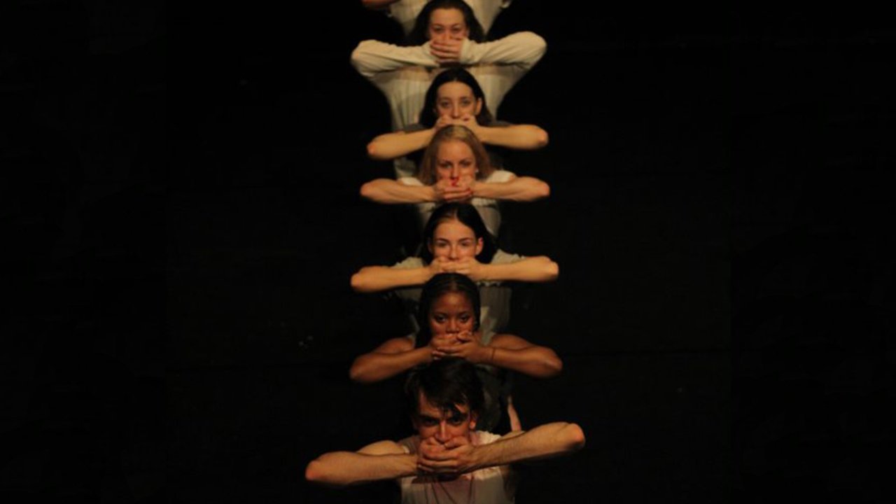 Dancers lined up in a row striking a pose